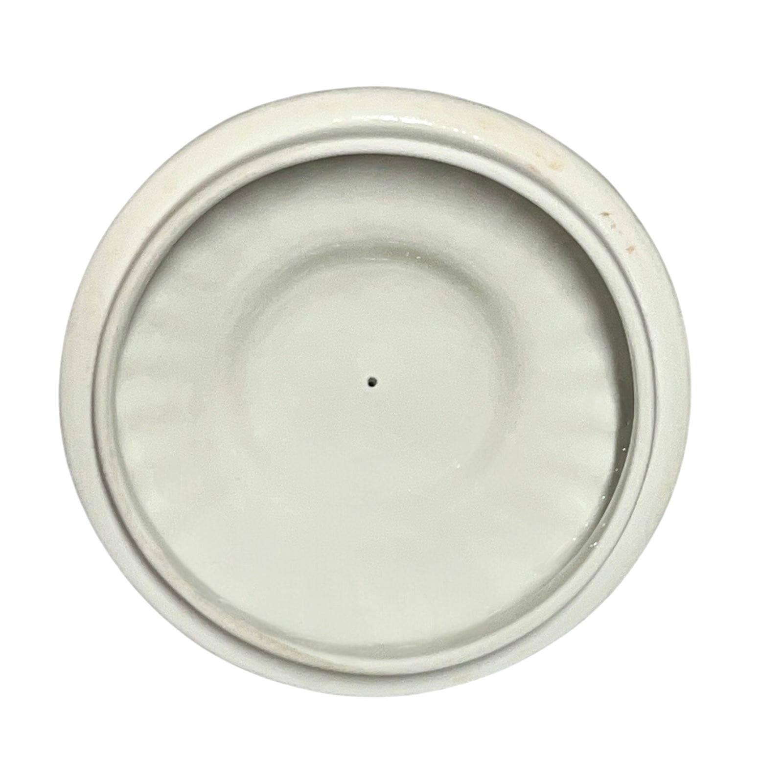 Round ceramic lid with a white glaze on a white background