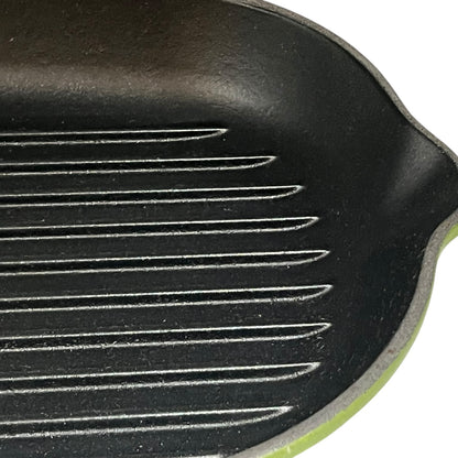 Close-up of a black cast iron skillet with ribbed surface