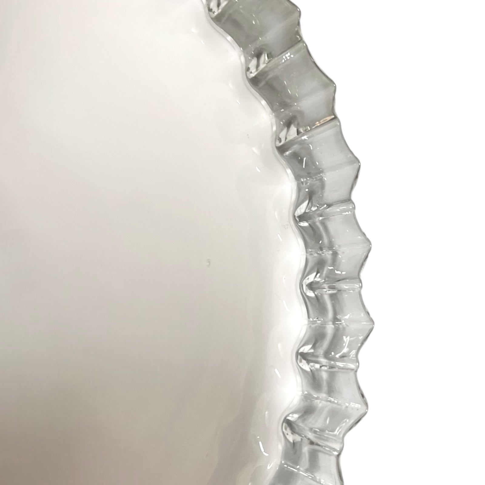Clear glass vase with wavy design on a white background