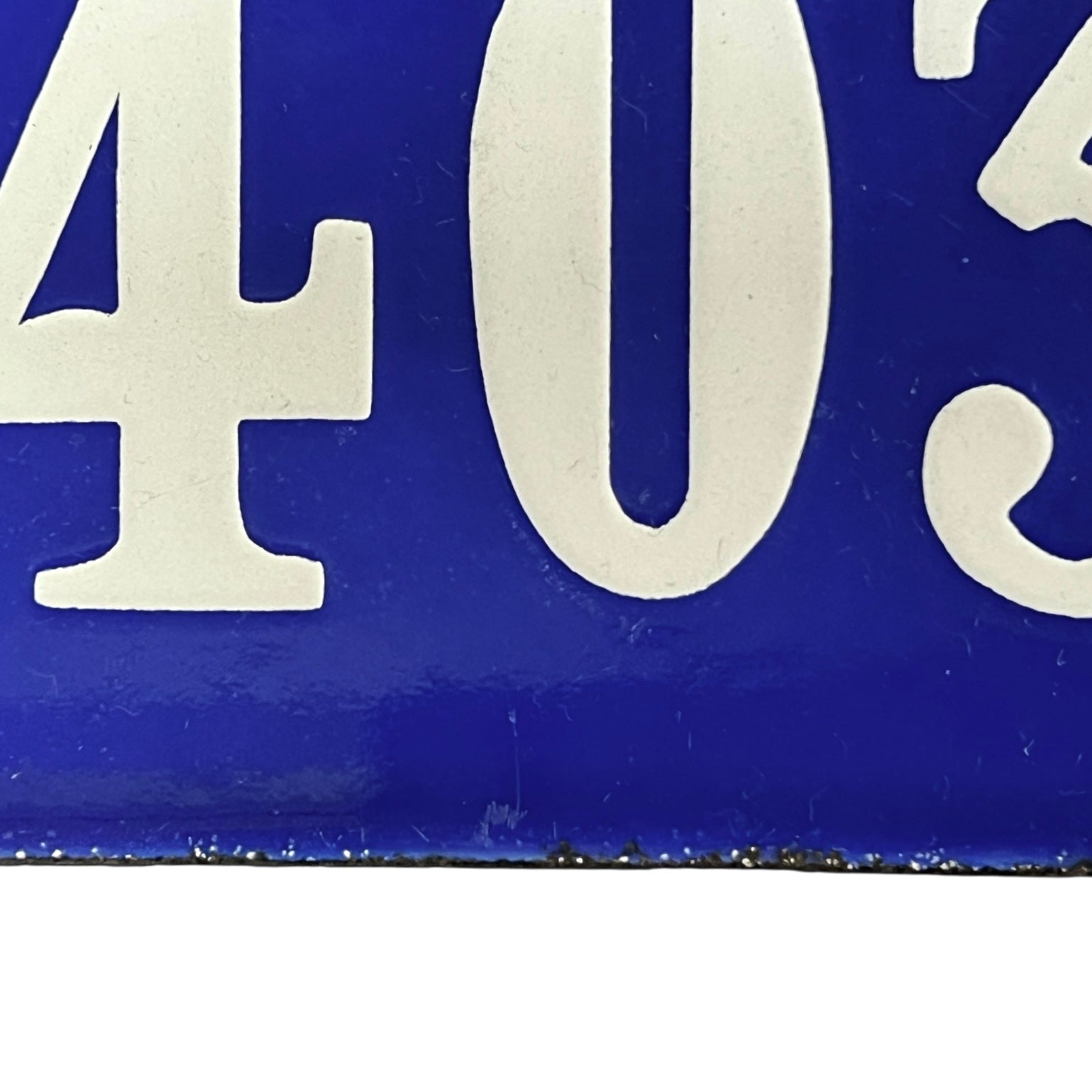 Close-up of a blue and white sign with numbers