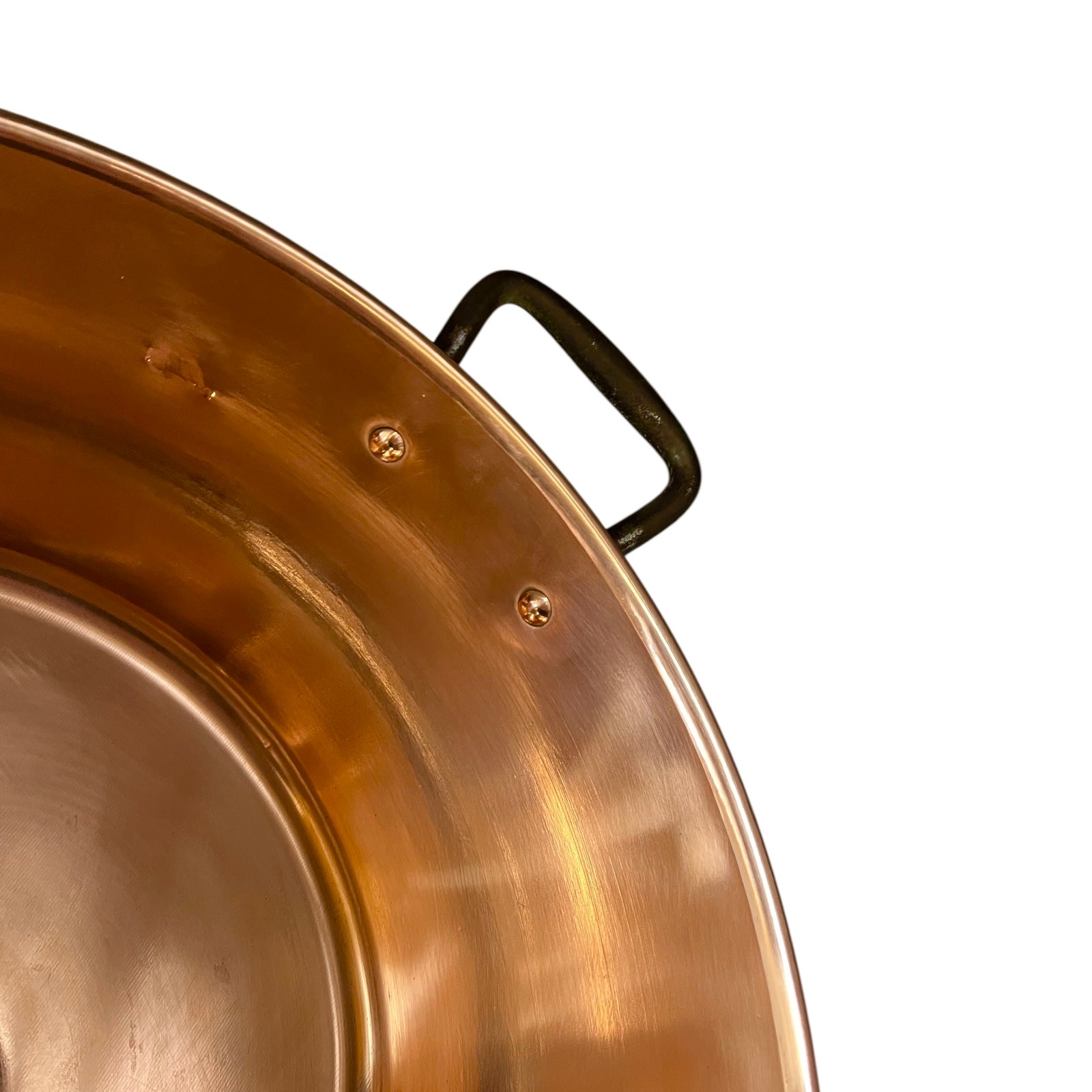 Close up of French copper bowl upcycled into a copper sink with iron handles and a chrome pop up waste on a white background