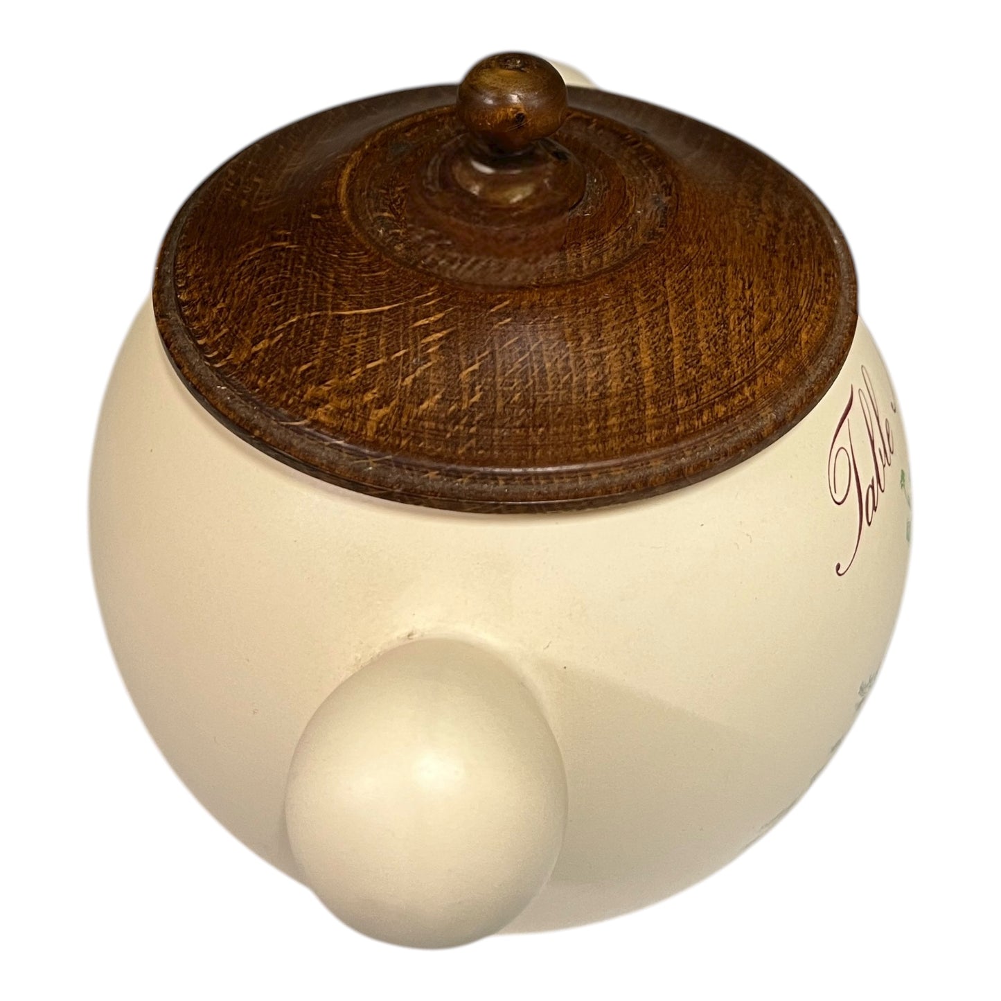 Round wooden object with a wooden brown top and smooth beige bottom on a white background