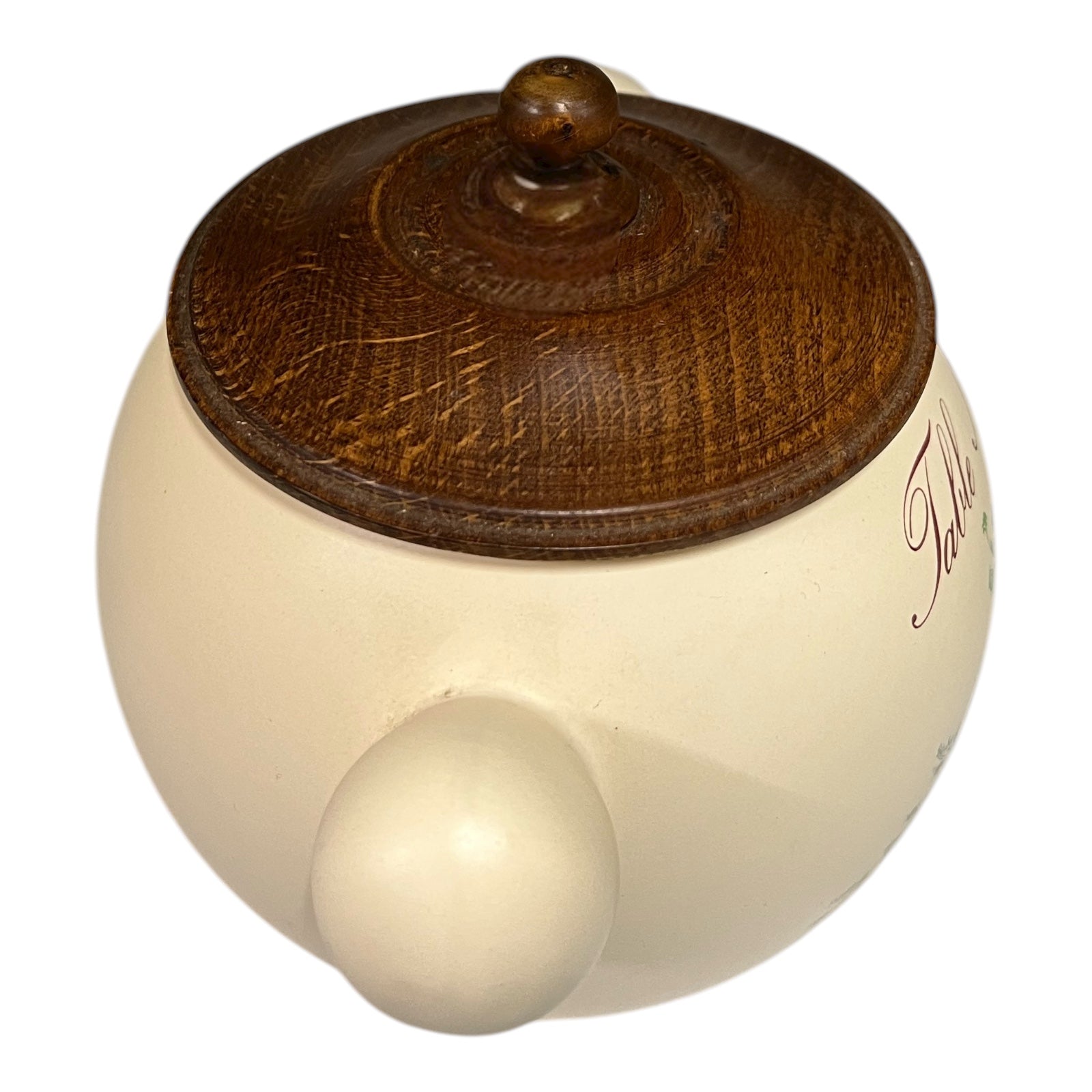 Round wooden object with a wooden brown top and smooth beige bottom on a white background