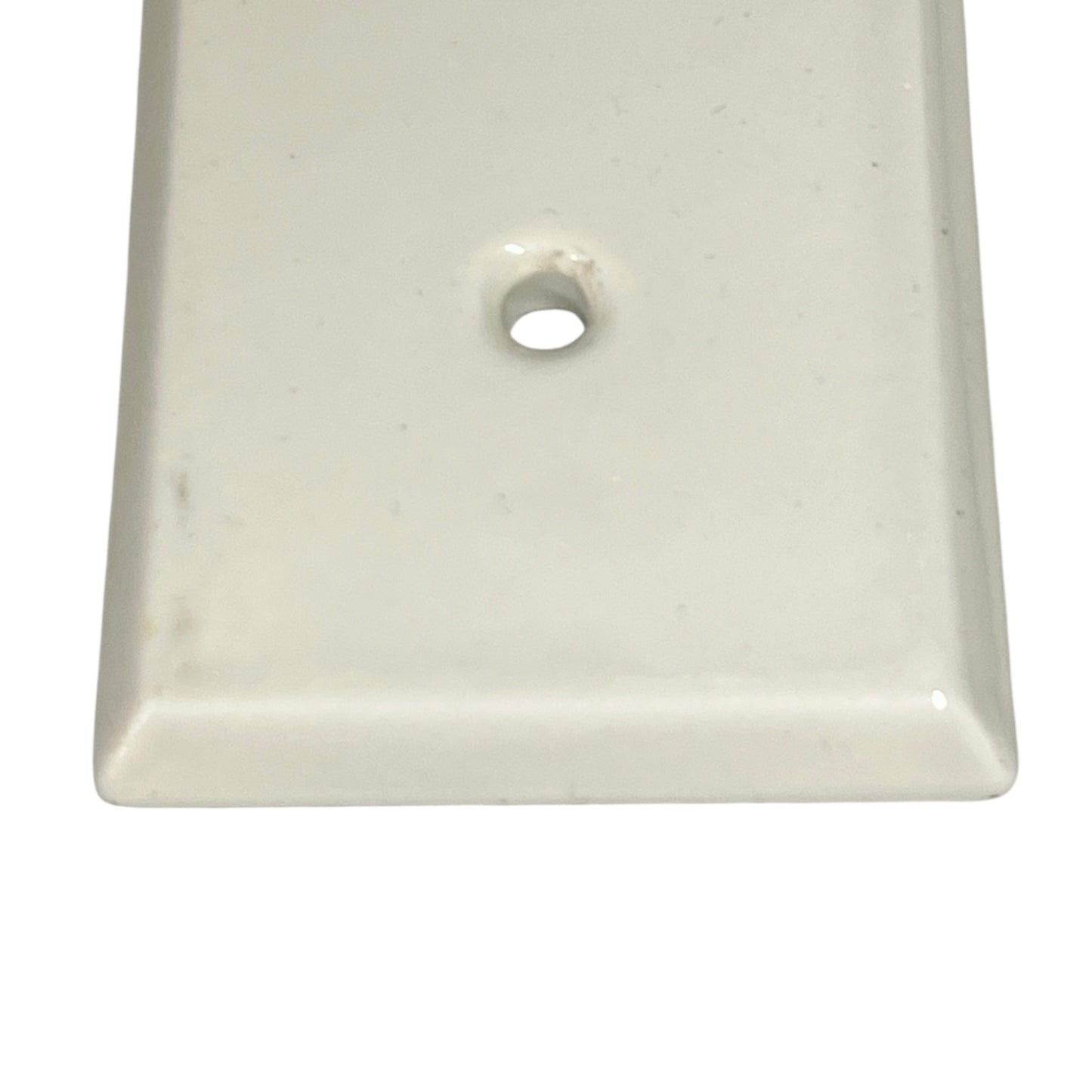 Close up of a finger push plate on a white background