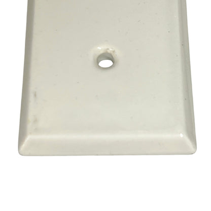 Close up of a finger push plate on a white background