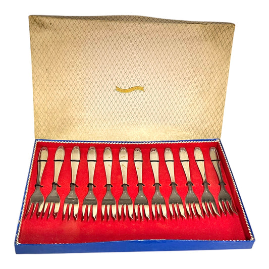 Set of silver forks in a decorative box with a red interior