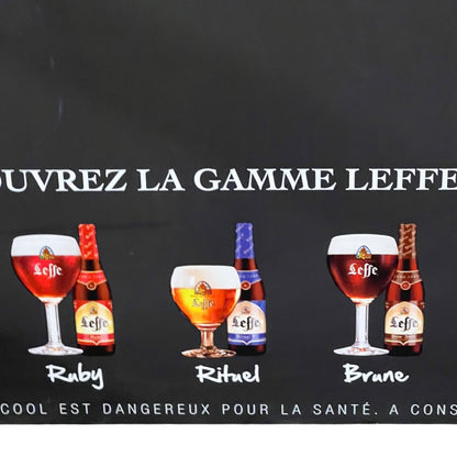 Promotional image of Leffe beer bottles and glasses on a black background with text.