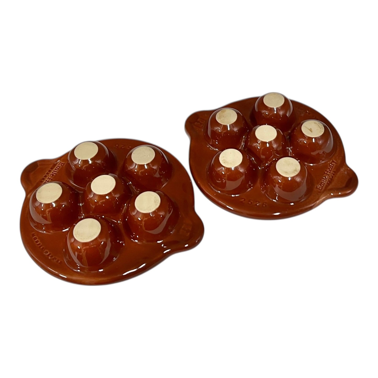 Brown ceramic egg ,snail, or escargots plates with multiple compartments on a white background