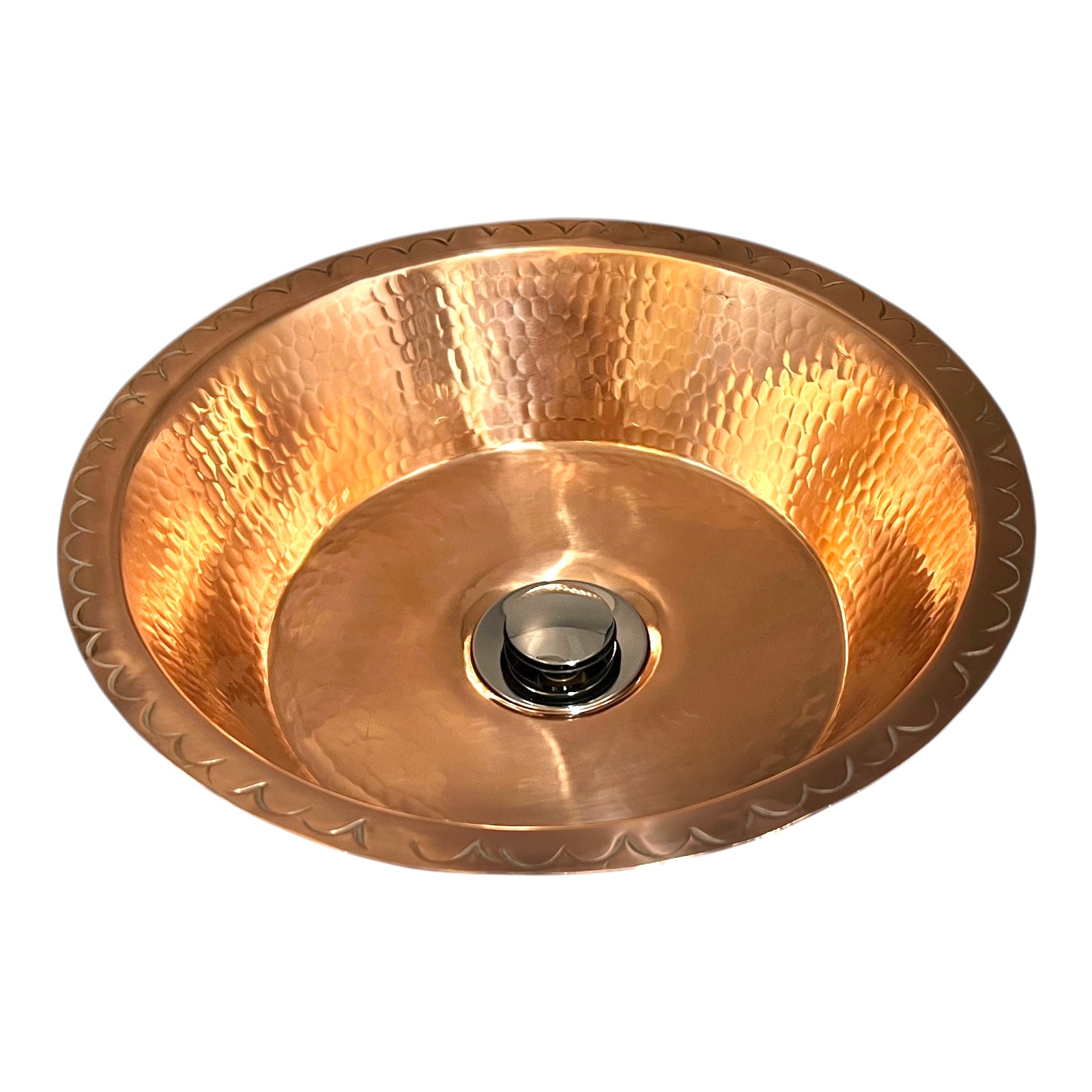 Copper sink with embossed design on a white background