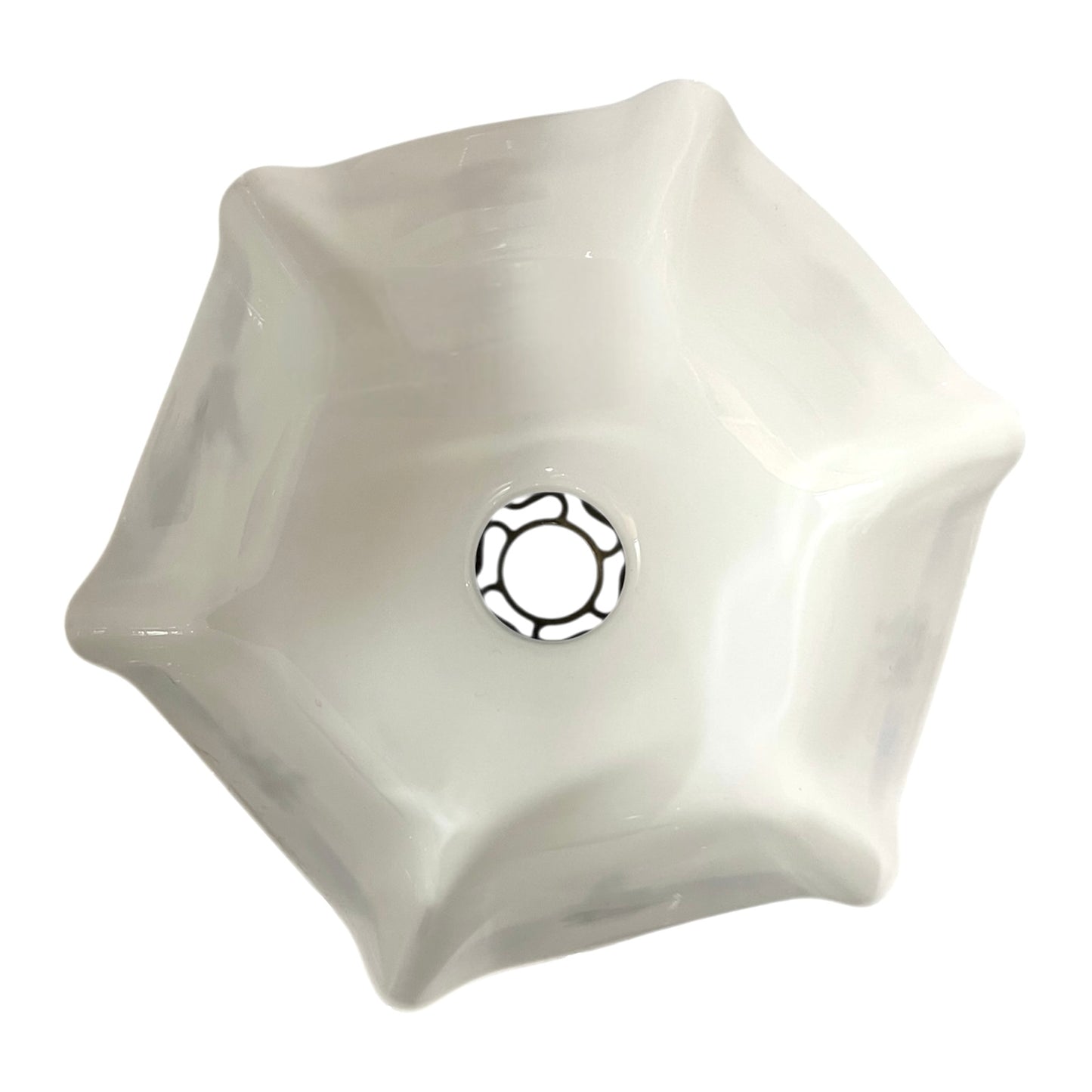 Close up of a white glass lamp shade with decorative design on a white background