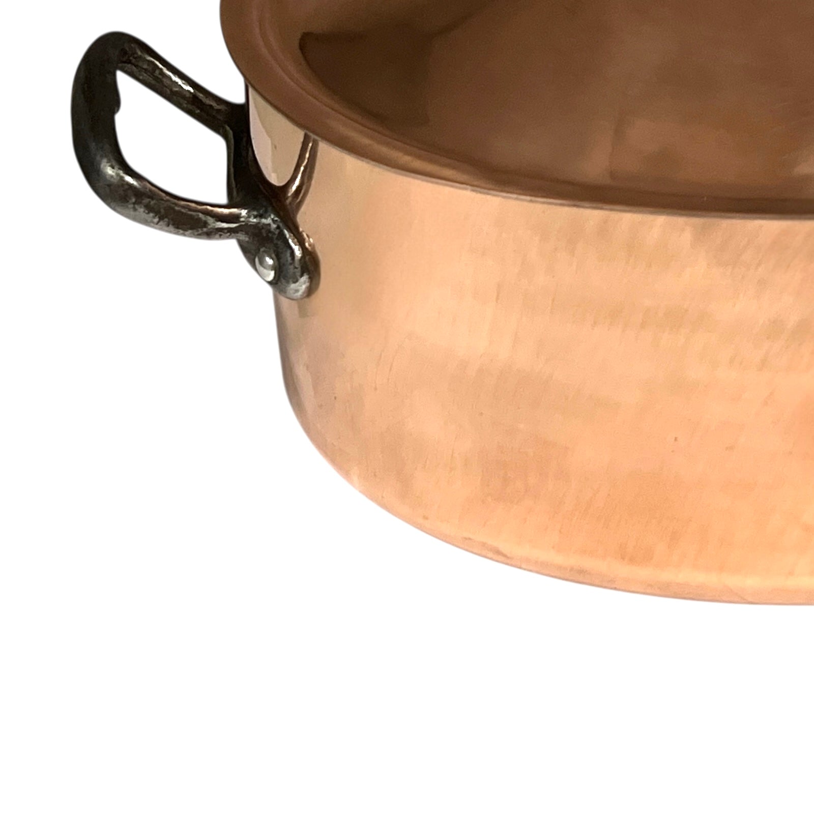 Close-up of a copper pot with a handle on a white background