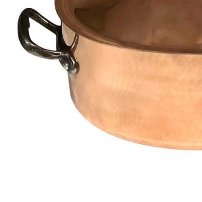 Close-up of a copper pot with a handle on a white background