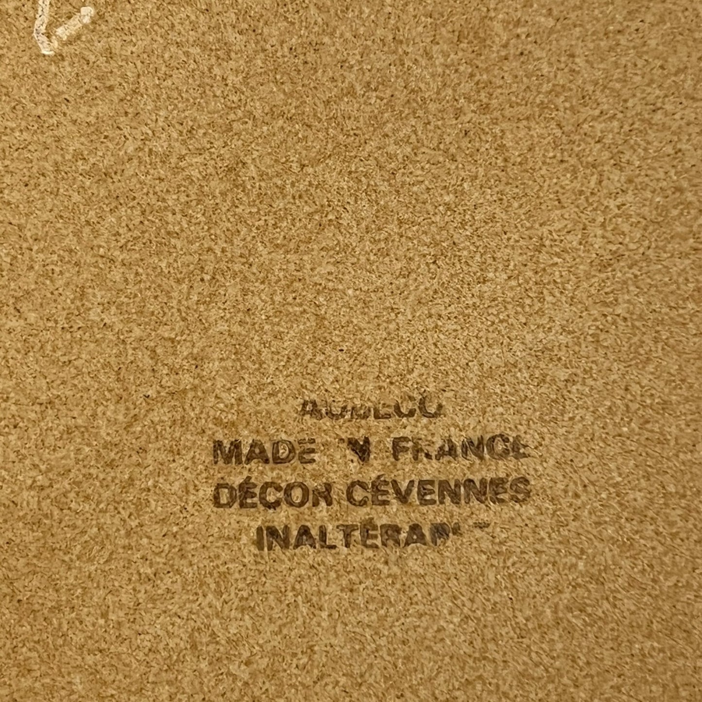 Text on a brown background with 'Made in France' and brand name.