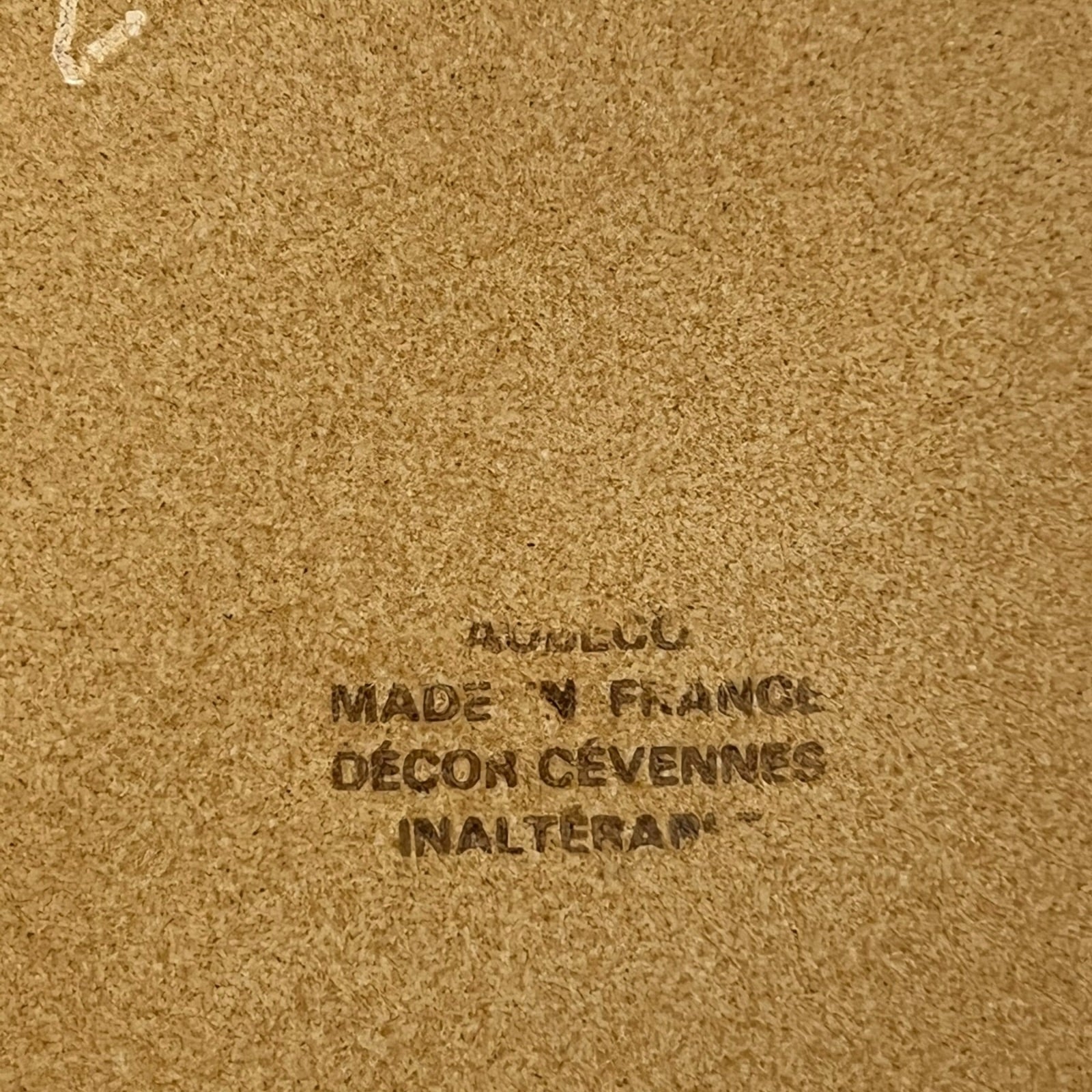 Text on a brown background with 'Made in France' and brand name.