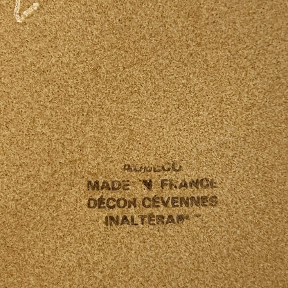 Text on a brown background with 'Made in France' and brand name.
