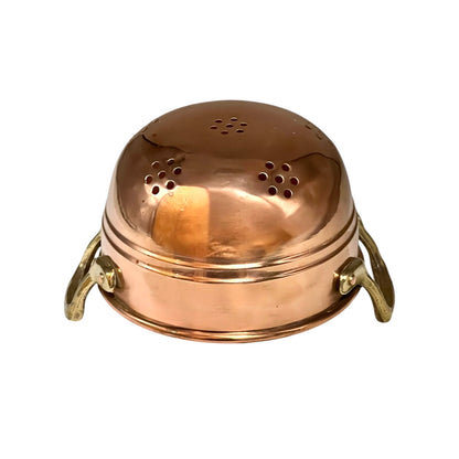 A vintage copper colander with a domed lid featuring multiple drainage holes and two brass side handles, shown against a plain white background.