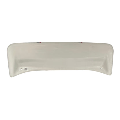 A curved, off-white ceramic underside of a shelf, shown against a plain white background