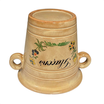Beige ceramic ice bucket with floral designs and text on a white background