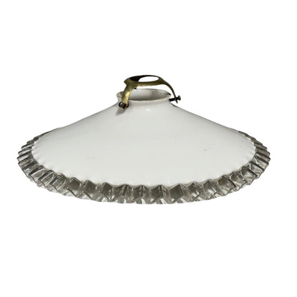 White round vintage glass lampshade with a frilled clear edge and a brass collar on a white background