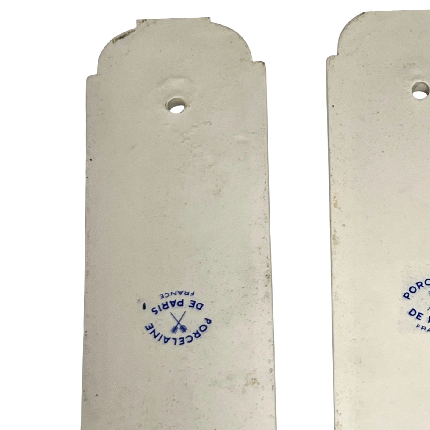 Close up of the back of a pair of finger push plates on a white background