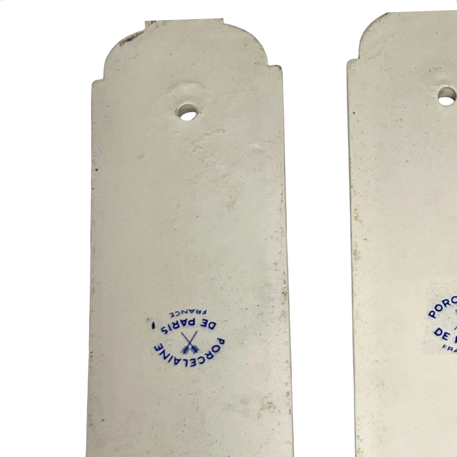 Close up of the back of a pair of finger push plates on a white background