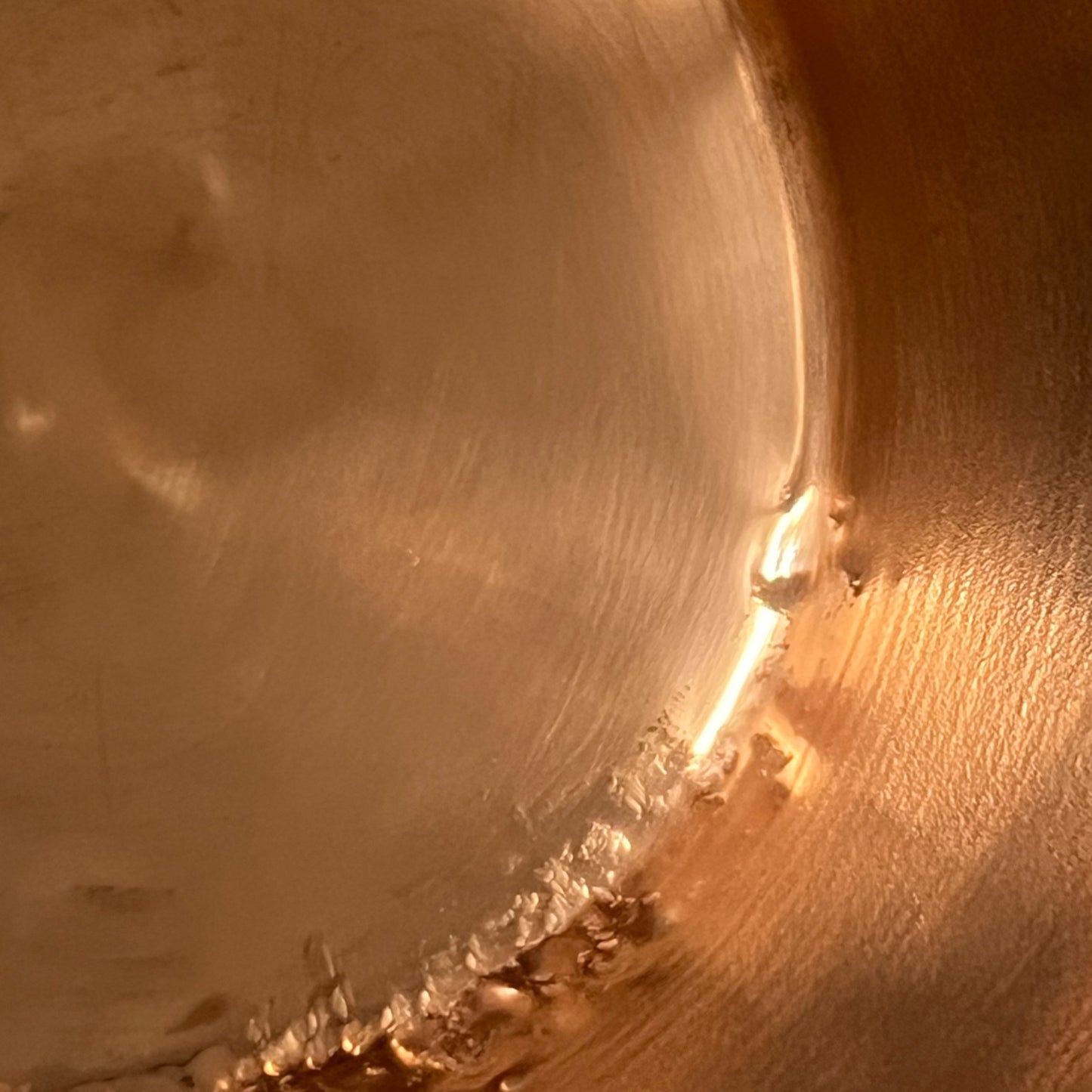 Close up of French vintage copper ladle pan with a black handle on a white background