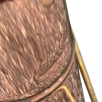 close up of a French copper garden sprayer on a white background 