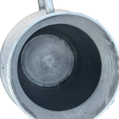 Close up of a Vintage French aluminium milk churn with a lid on a white background
