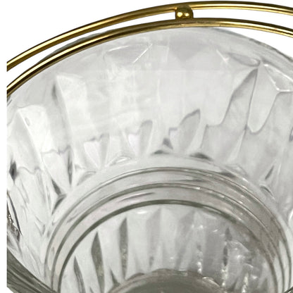 Clear glass candle holder with gold rim on a white background