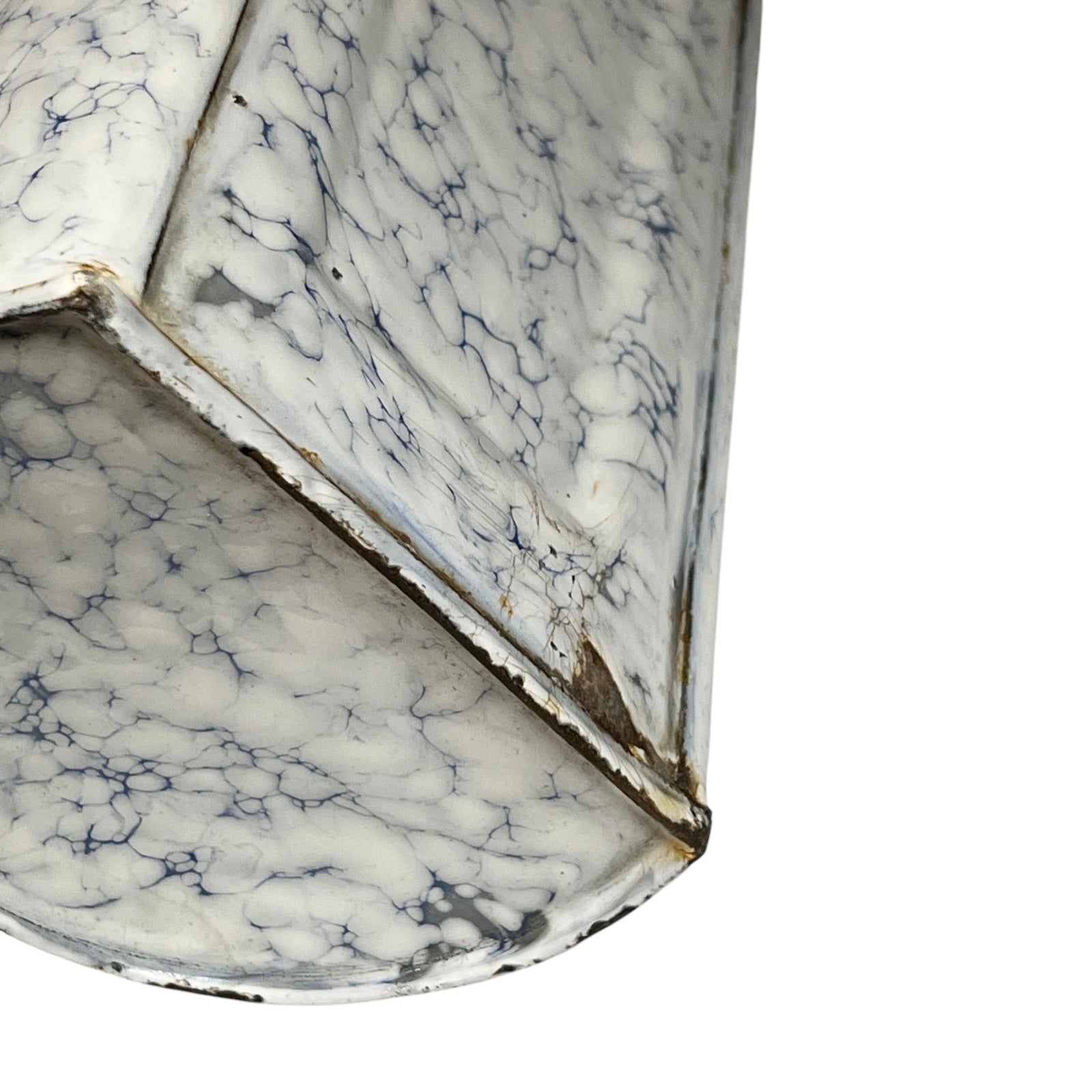 A close-up of a white marble-patterned metal irrigator or decorative container with dark veining and weathered edges, shown against a plain white background.