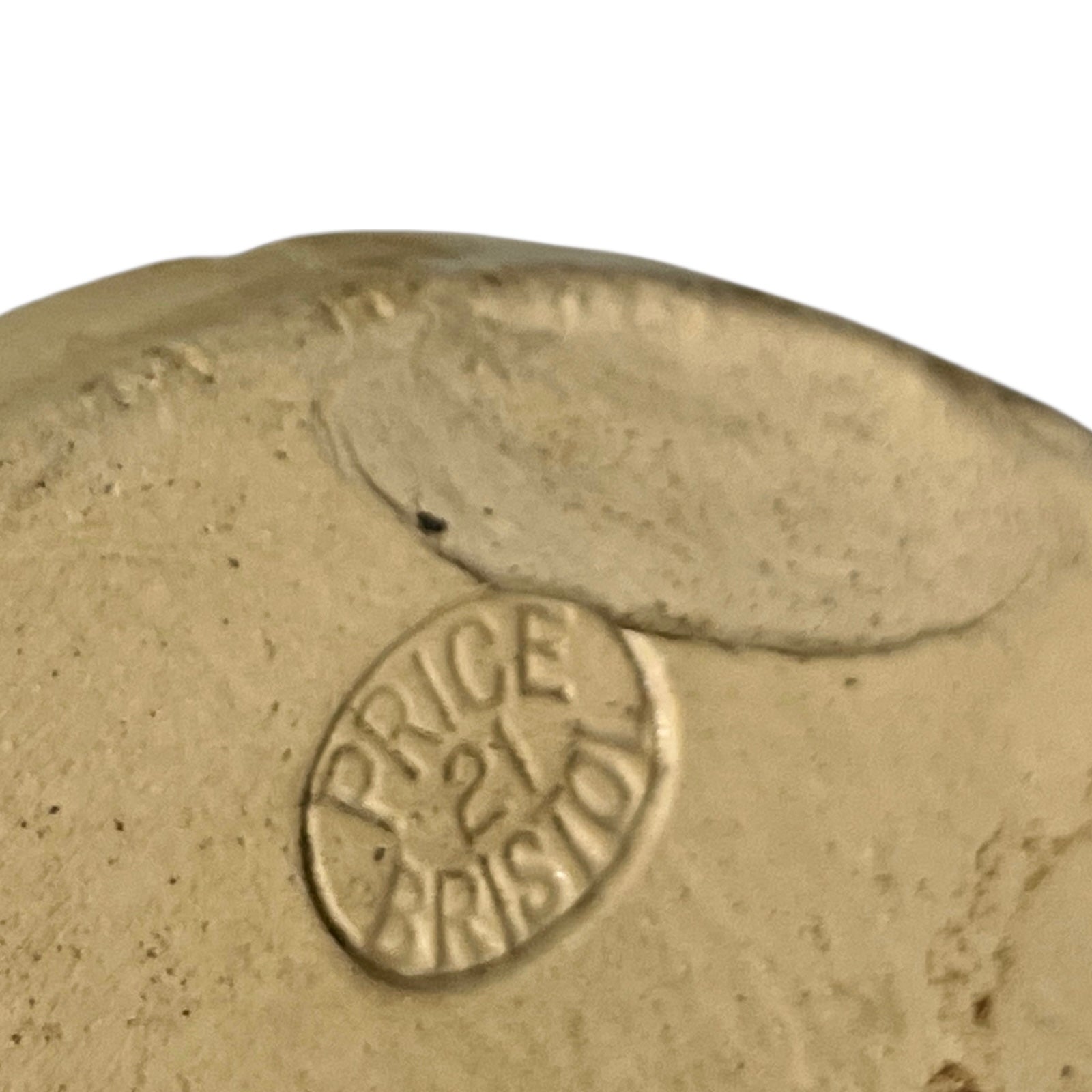 Close up of a beige cylindrical WW1 jar on a white background