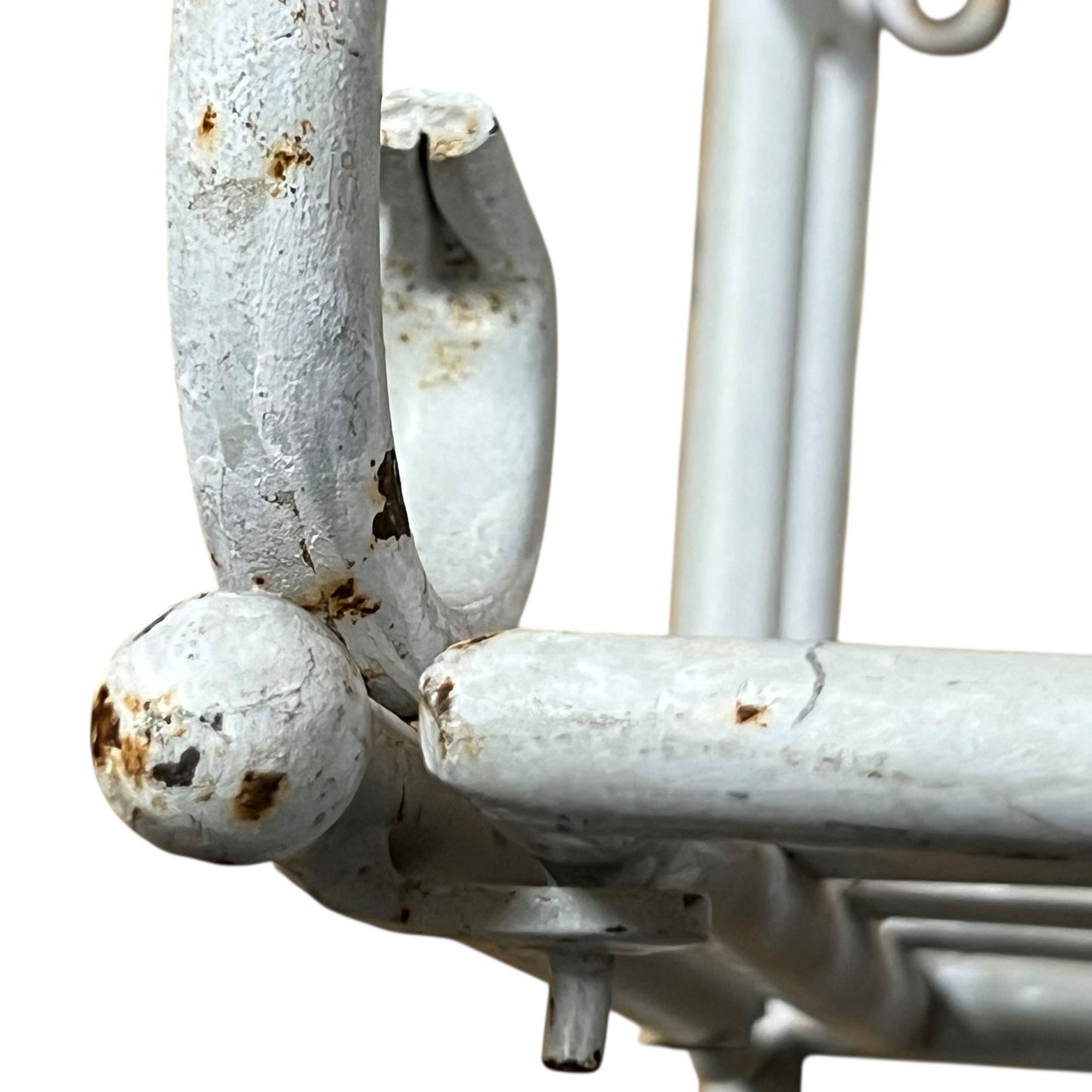 Close-up of a metal she with visible wear and tear on a white background