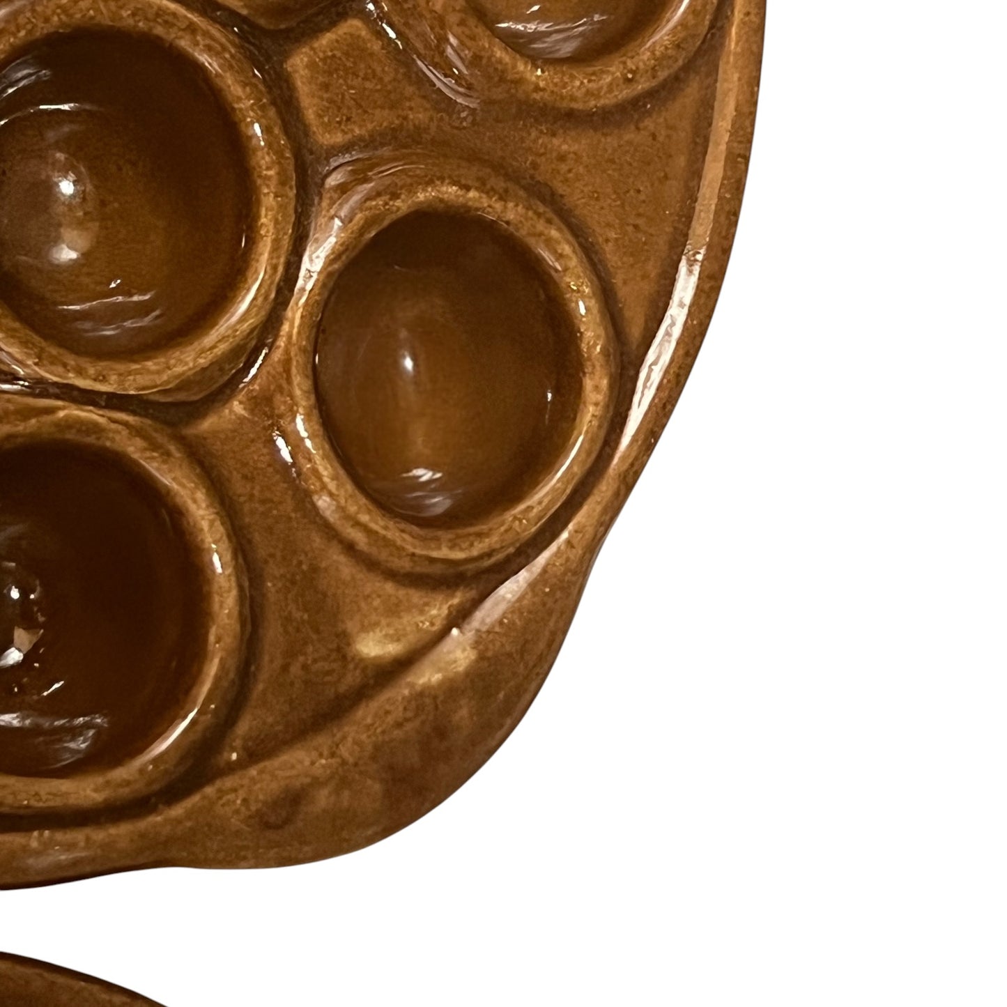 Close-up of a French escargot serving plate against a white background.