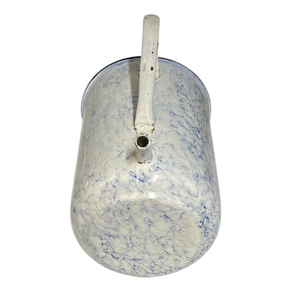 A vintage enamel pot with a white body featuring a blue marbled pattern, a white handle, and a small spout, shown against a plain white background.
