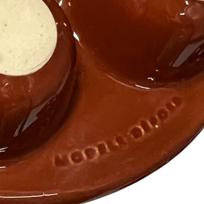 Close-up of a brown ceramic plate on a white background
