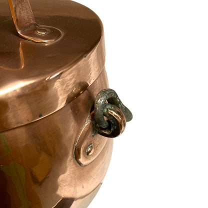 Close up of a copper cooking pot stockpot with handles on a white background
