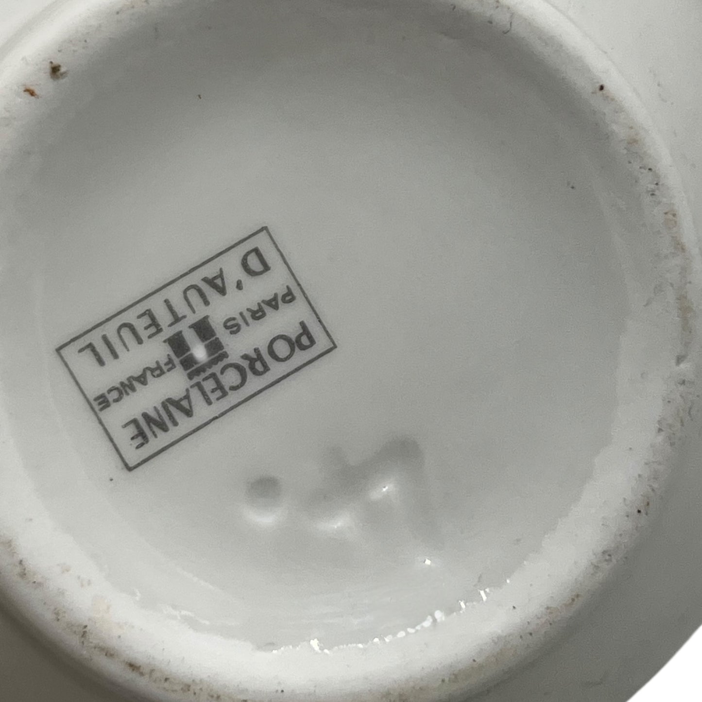 Close-up of a Porcelaine de France logo on a ceramic product