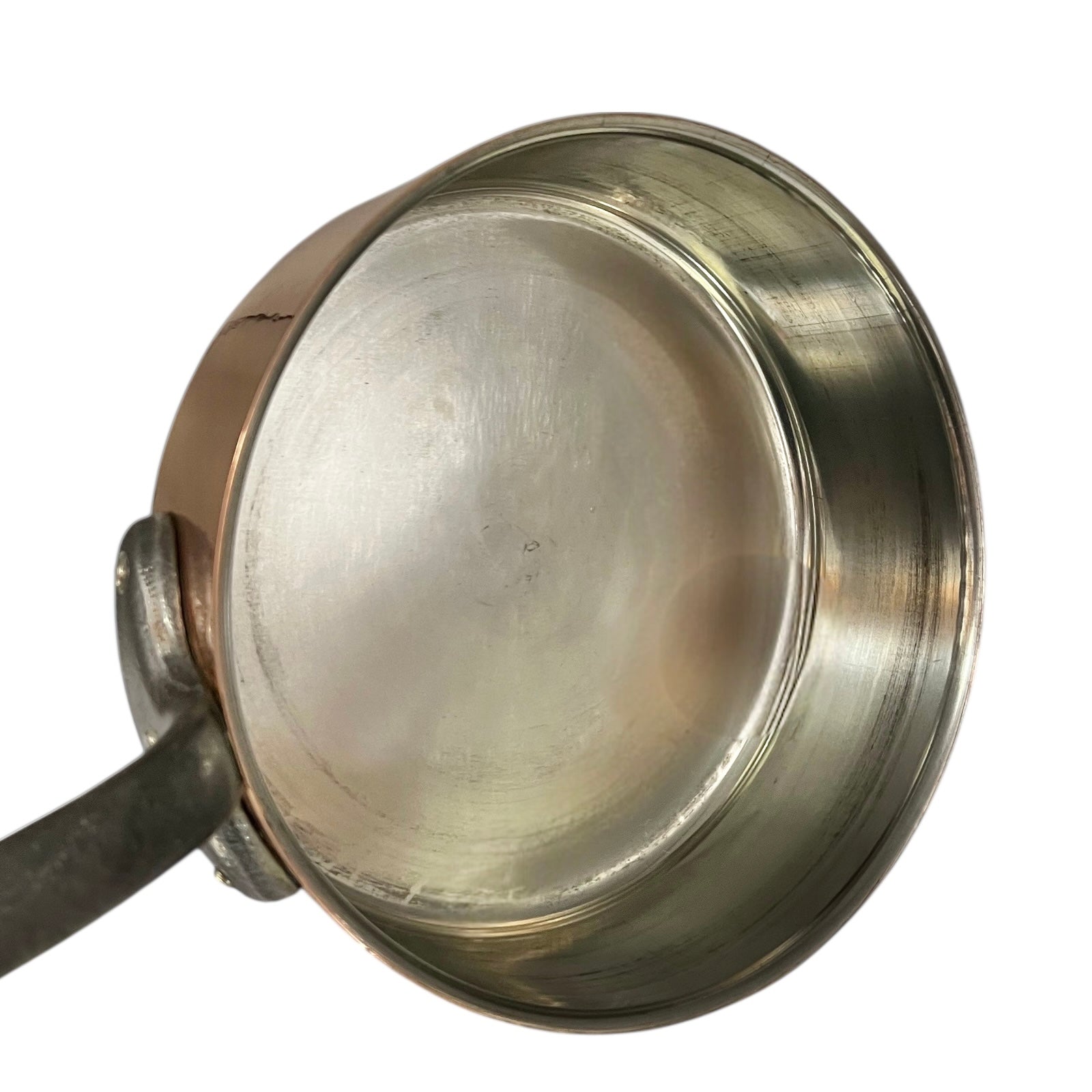 inside of copper pan with tin lining on a white background