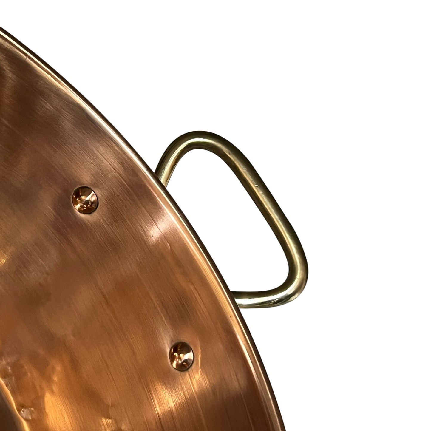 Close-up of a copper up cycled sink with brass handles on a white background.