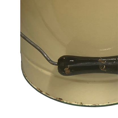 Close up of French vintage cream and green enamel bucket with a lid and handle on a white background