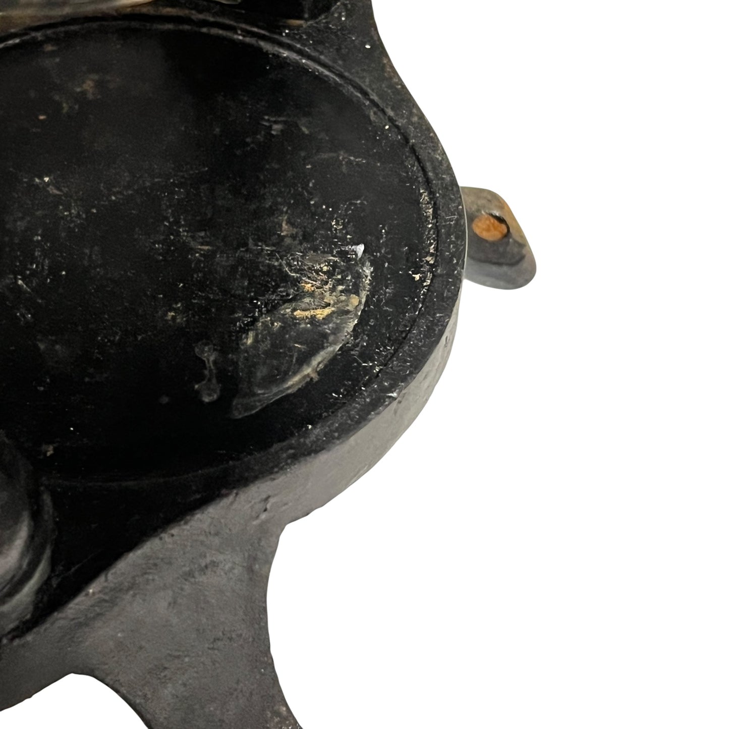 Close-up of a black metal clamp on a white background