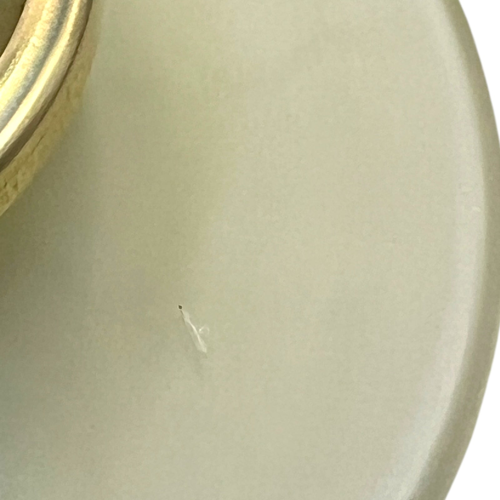 Close-up of a milk glass shade on a white background