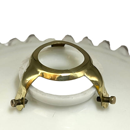 close up of white glass lampshade with a brass clasp gallery