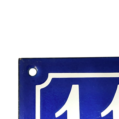 Blue sign with white symbol on a white background