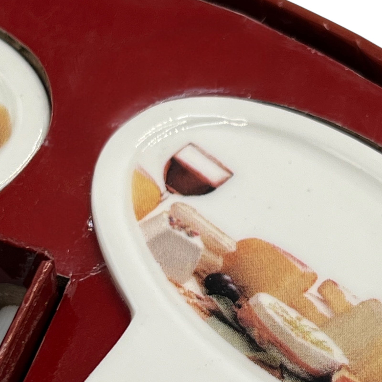 Close up of a porcelain cheese label in a red box on a white background
