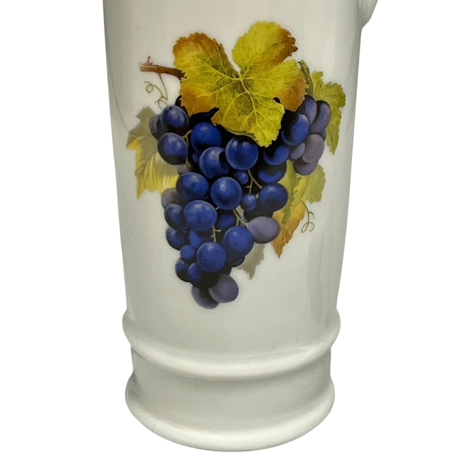 White decanter with a design of blue grapes and yellow leaves on a white background