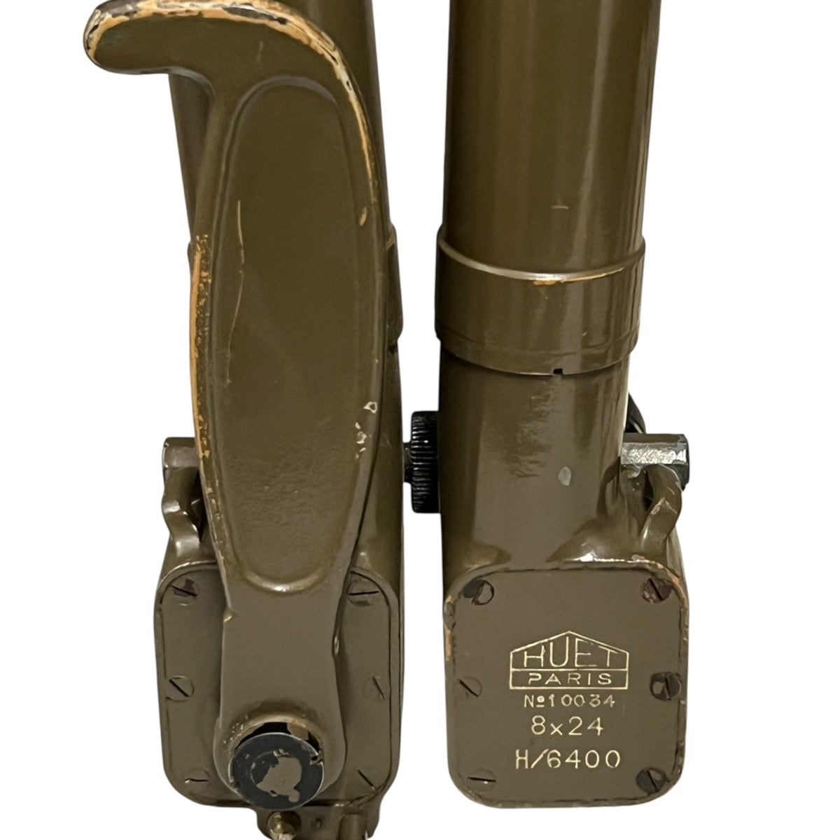 Close-up of a military-style metal support frame or bracket in olive drab green, showing a latch-like lever on the left and a cylindrical section with stamped markings on the right, isolated on a white background.