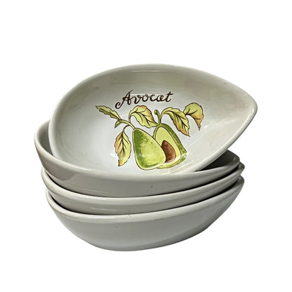 A stack of four white ceramic bowls, with the top bowl tilted to display a printed illustration of an avocado and the word 'Avocat' in script.