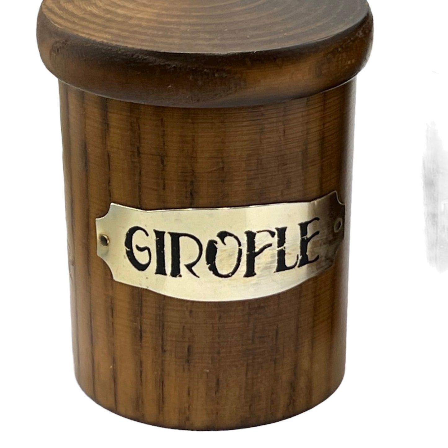 Wooden container with a brass label reading 'Girofle' on a white background
