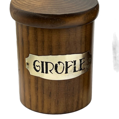 Wooden container with a brass label reading 'Girofle' on a white background